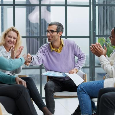 A diverse business team huddling in an office.