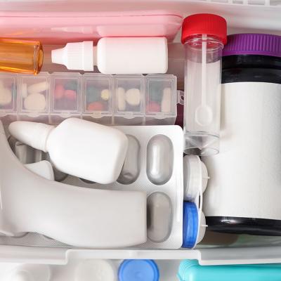 First aid kit with medical supplies arranged in a container box.