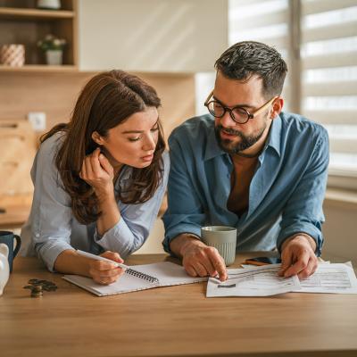 A couple reviewing finances in their home kitchen.