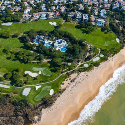 Aerial view of the iconic Crimson Cliffs of Praia do Trafal in Algarve, Portugal.