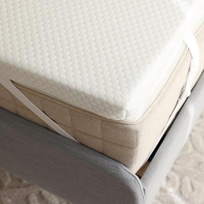 A grey bed with a brand new memory foam mattress.