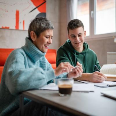 A mother helping her son with paperwork.