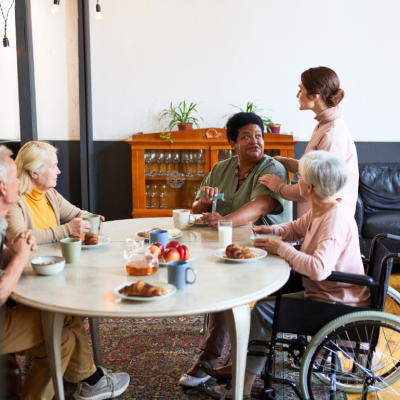 A group of older people at a table having breakfast.