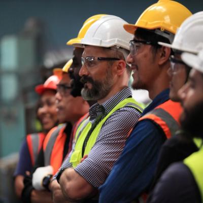 A group of workers in safety vests and helmets.