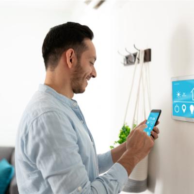 A man setting up his smart home devices with his smartphone