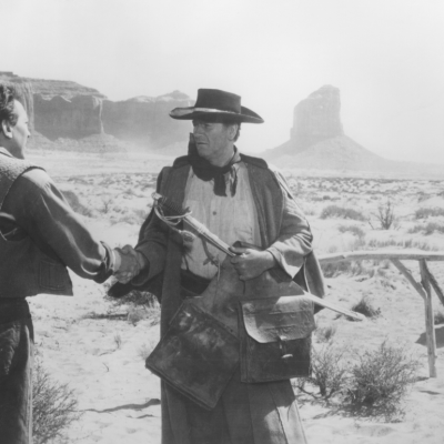 John Wayne as Ethan Edwards greets his brother Aaron, played by Walter Coy in front of Monument Valley , Utah, in a scene from the 1956 John Ford directed western 'The Searchers'.