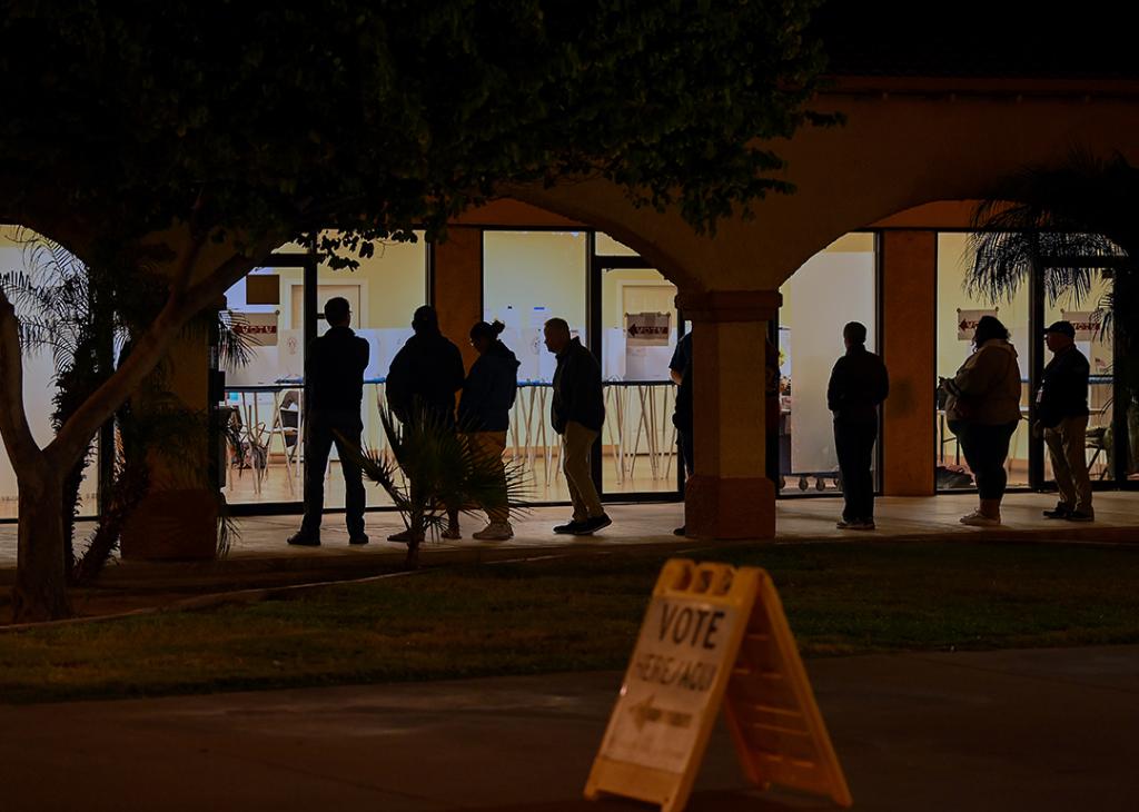 Voters wait in line at a polling station at the Guadalupe Mercado shopping mall in Guadalupe, Arizona.