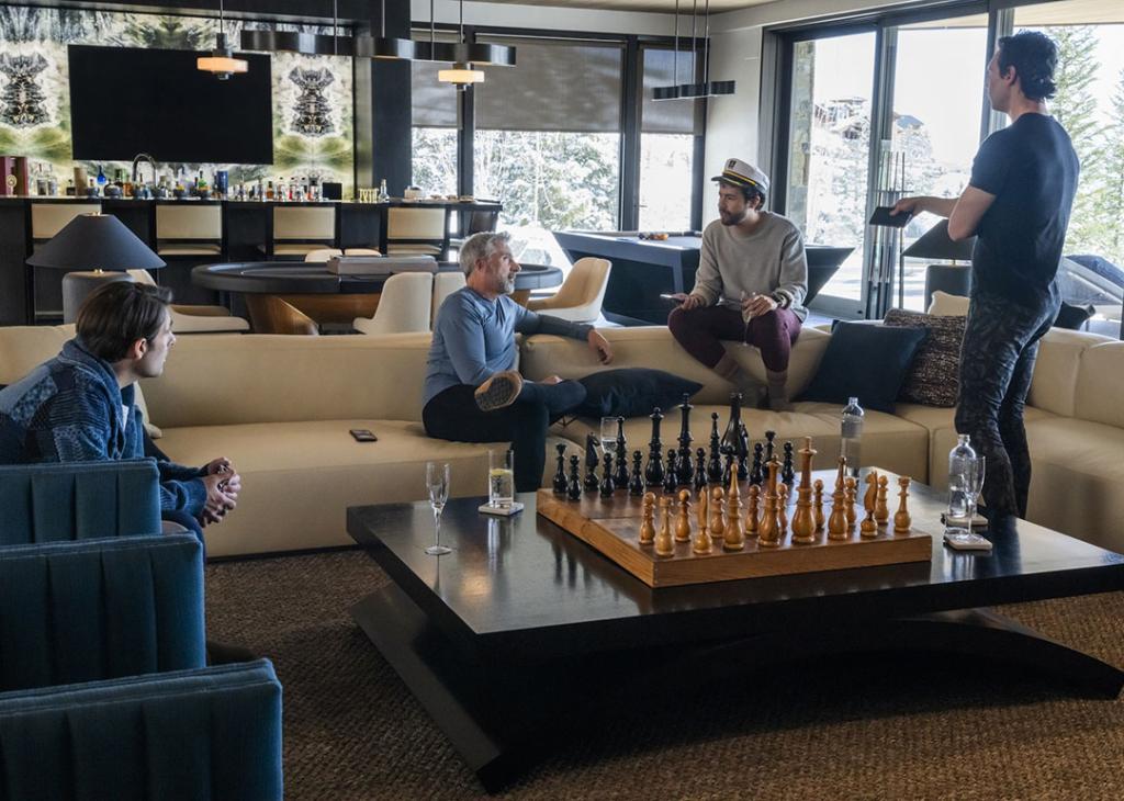 Jason Schwartzman, Steve Carell, Ramy Youssef, Cory Michael Smith in the mansion with a lavish chess set in the foreground on set filming Mountainhead
