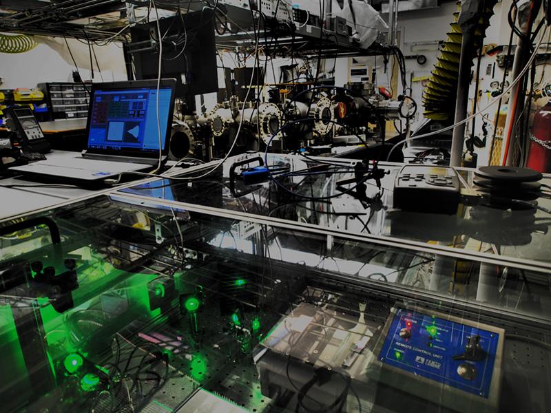 Stephen Leone’s lab full of equipment like vacuum chambers, vibration-suppression tables, lenses and crystal elements that shift, split and recombine laser beams, compress or expand light pulses and impart tiny delays into when pulses reach samples and detectors.