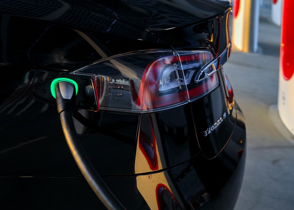 Charging port of a black Tesla Model S 75D car.