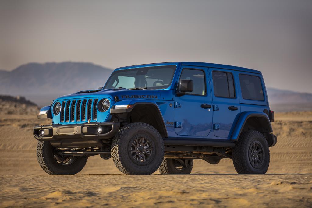 Shiny chief blue jeep wrangler rubicon parked in the desert.