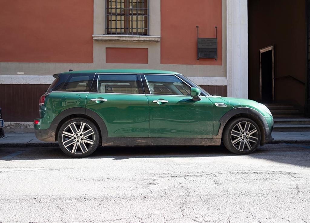 British Racing Green Mini Clubman Cooper S parked in urban setting in Italy.