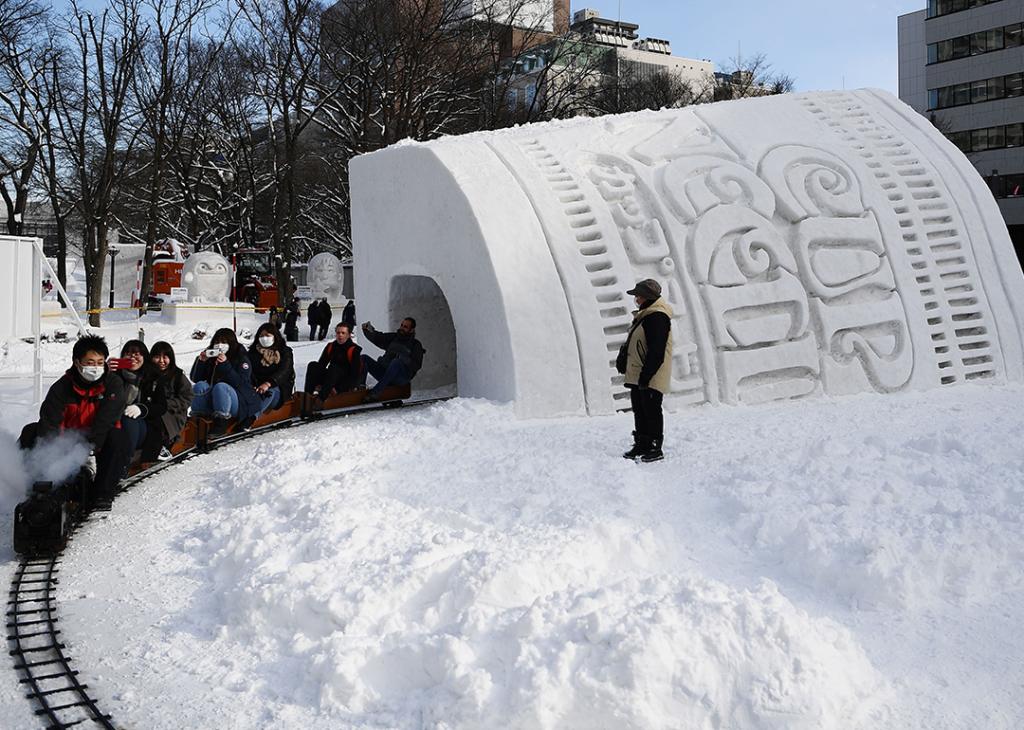 People ride through the Cup Noodles and Rui Hachimura's snow tunnel during the 2020 Sapporo Snow Festival in Hokkaido, Japan.