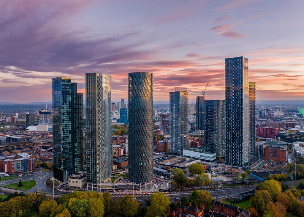 Aerial view of the Manchester city skyline at dawn.