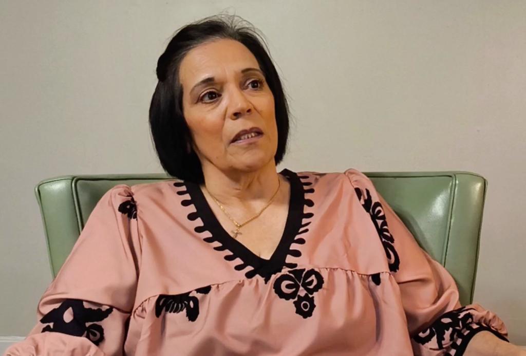 Former teacher Amy Franco, wearing a pink shirt with black detailing, speaks during an interview.   