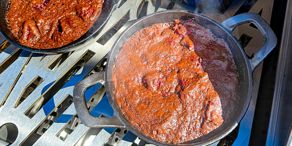 Raspberry brownies freshly baked in an iron skillet.