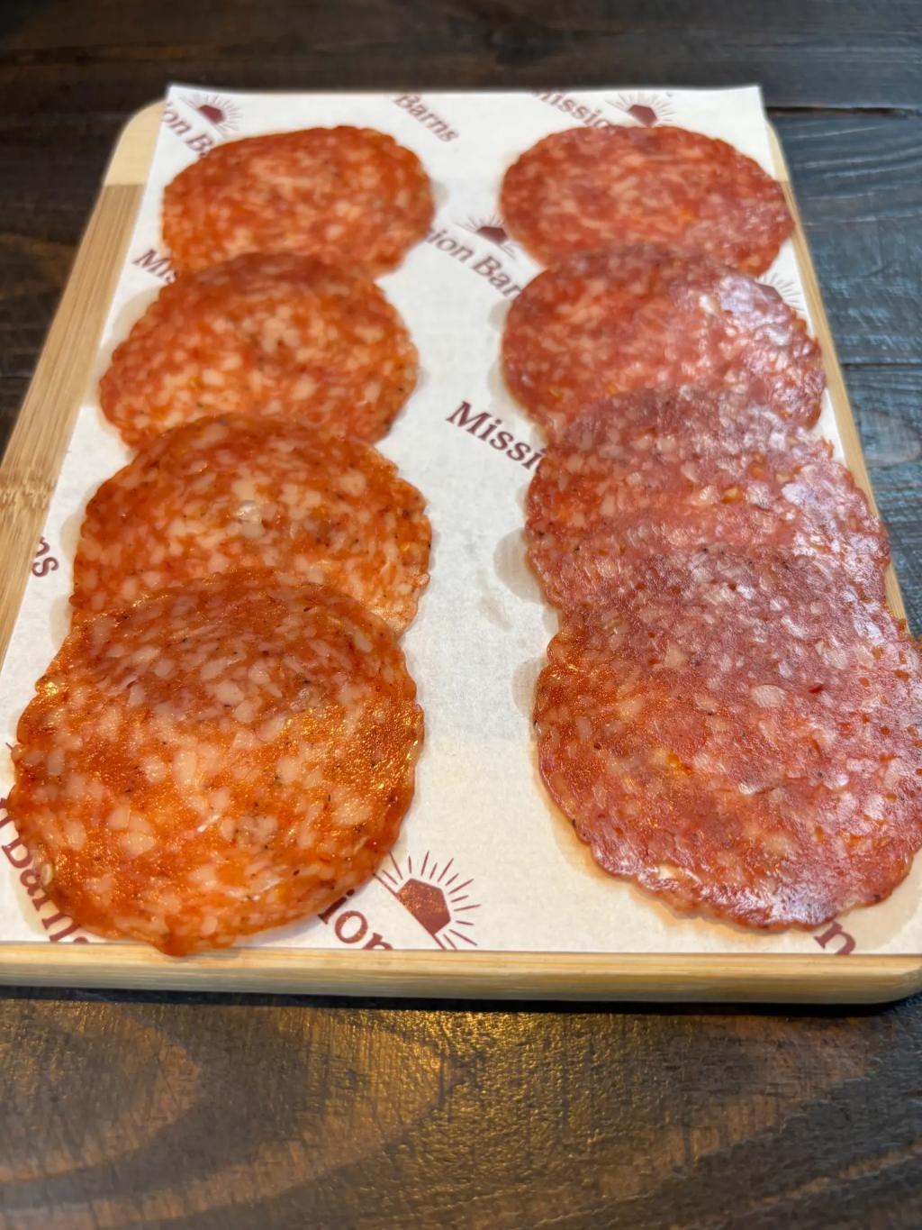A tray of sliced salami made from the cultivated pork meat.