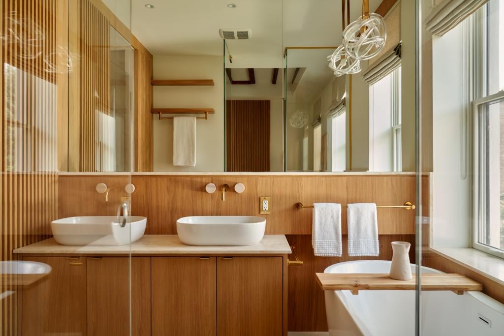 Interior of a modern bathroom with wall-mounted faucets.