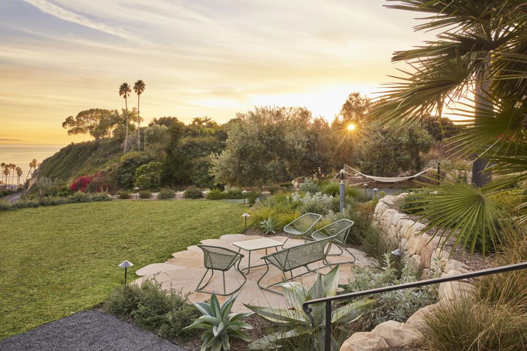 An outdoor garden facing the coast decorated with stone pathways.