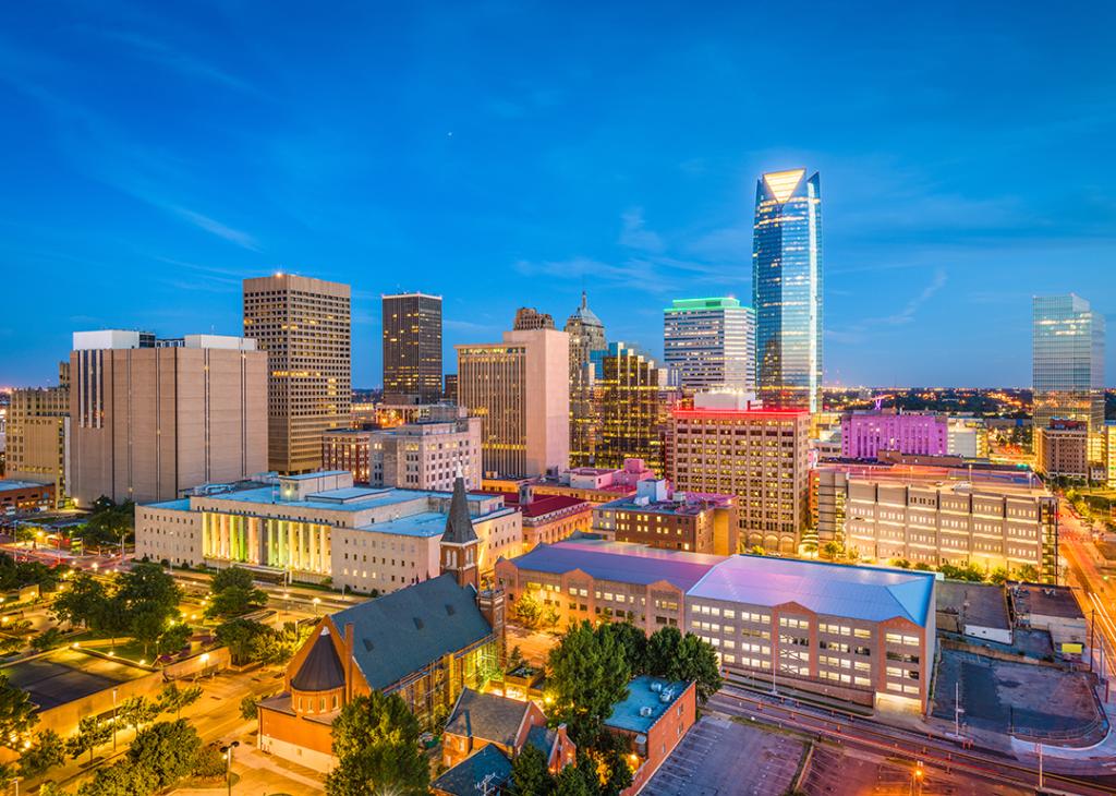 Aerial view of Oklahoma City's downtown skyline at twilight.