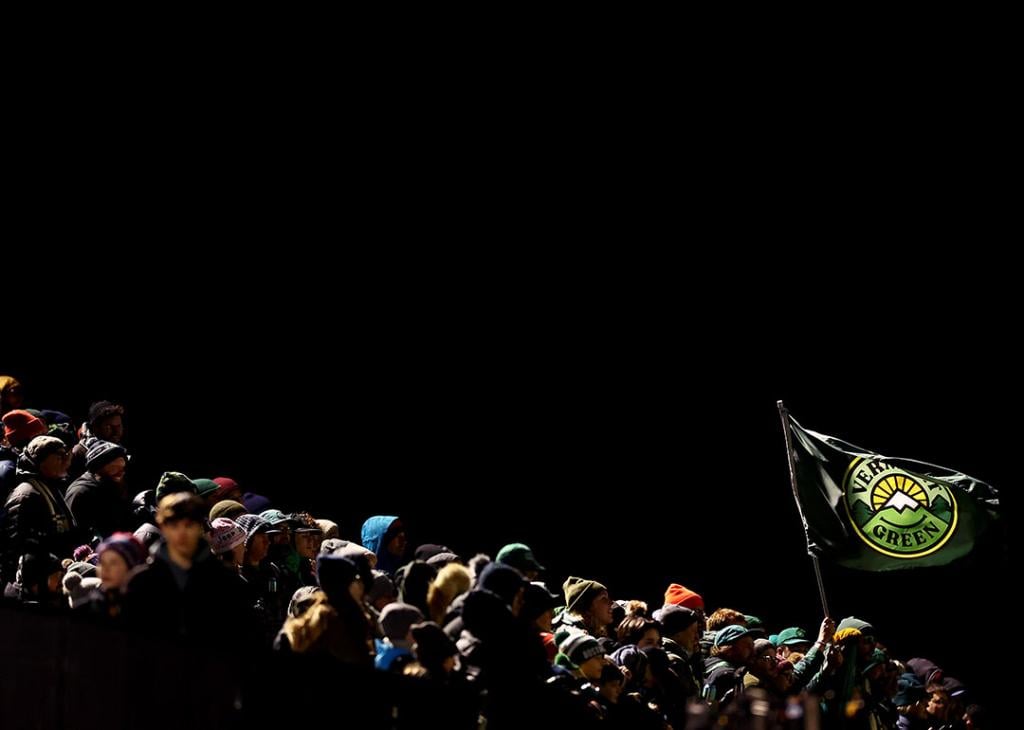 A Vermont Green FC flag waves stands out against a black background over fans during the First Round of the 2024 U.S. Open Cup at Virtue Field on March 19, 2024 in Burlington, Vermont.