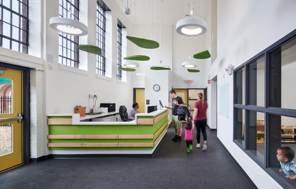 To make the Brynmor space inviting to a young child, the architects needed to “bring the scale down.” They used acoustic baffles to absorb sound and create the sense of a lower ceiling without obstructing the abundant natural light.