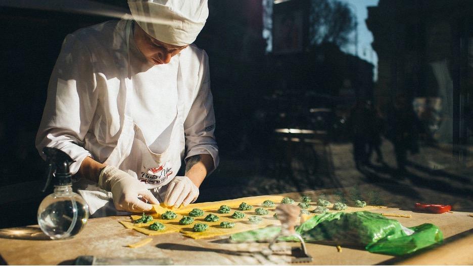 A chef preparing a ravioli pasta dish.