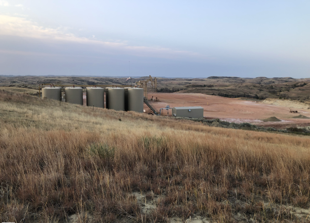 Tanks and pump jacks visible from the trail, near mile marker 78.