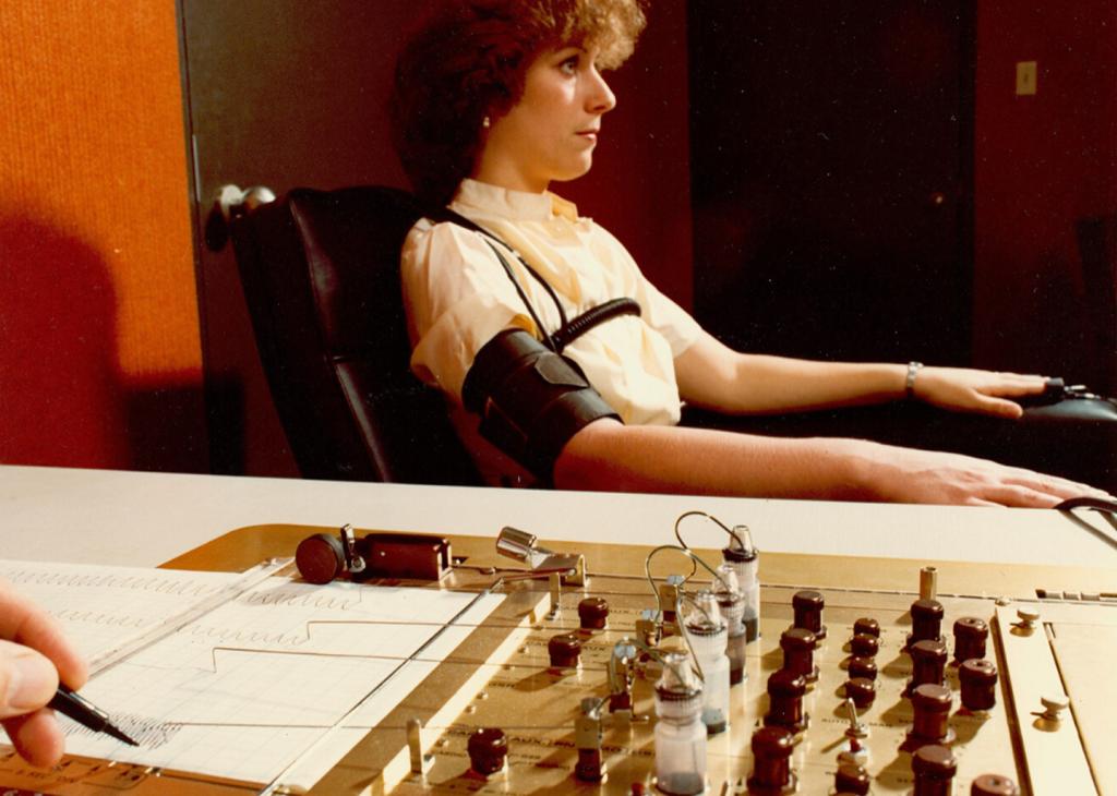 Vintage photo of a woman hooked up to a polygraph machine