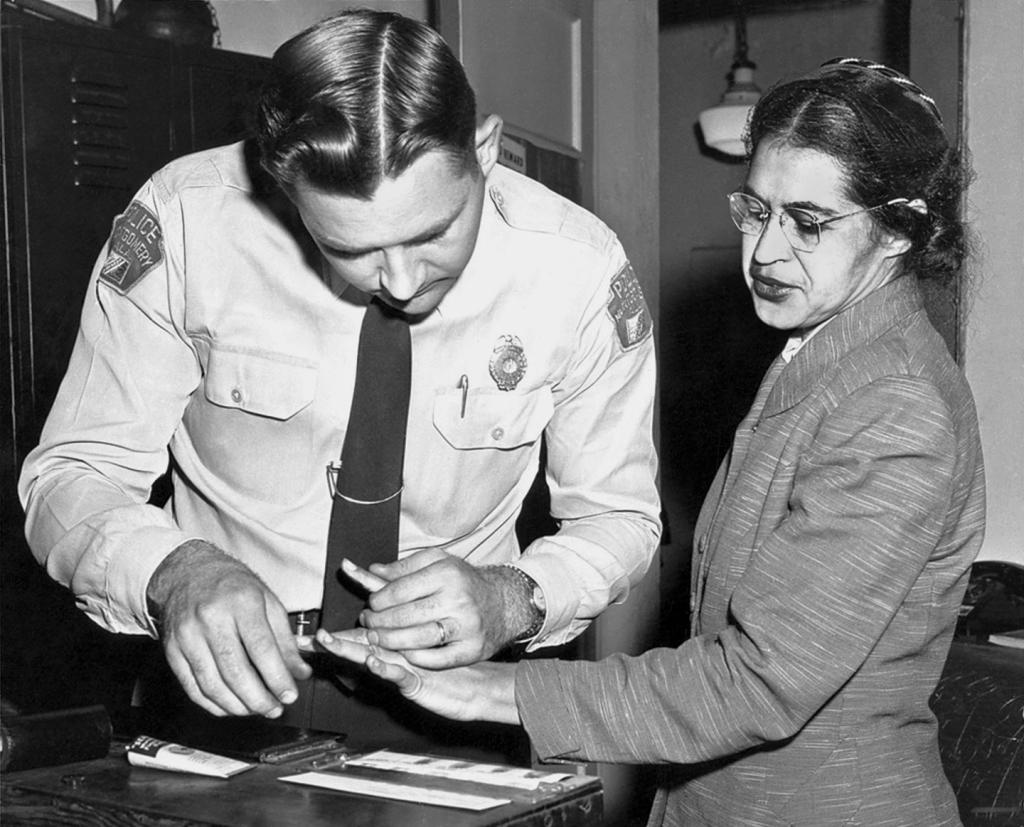 American civil rights activist, Rosa Parks is fingerprinted by Lieutenant DH Lackey in Montgomery, Alabama, after she was arrested during the Montgomery bus boycott.