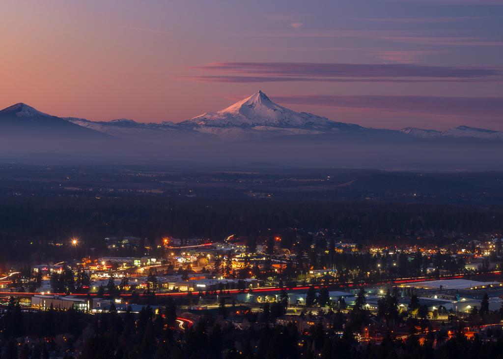 Bend, Oregon's cityscape with Mount Jefferson at sunset.