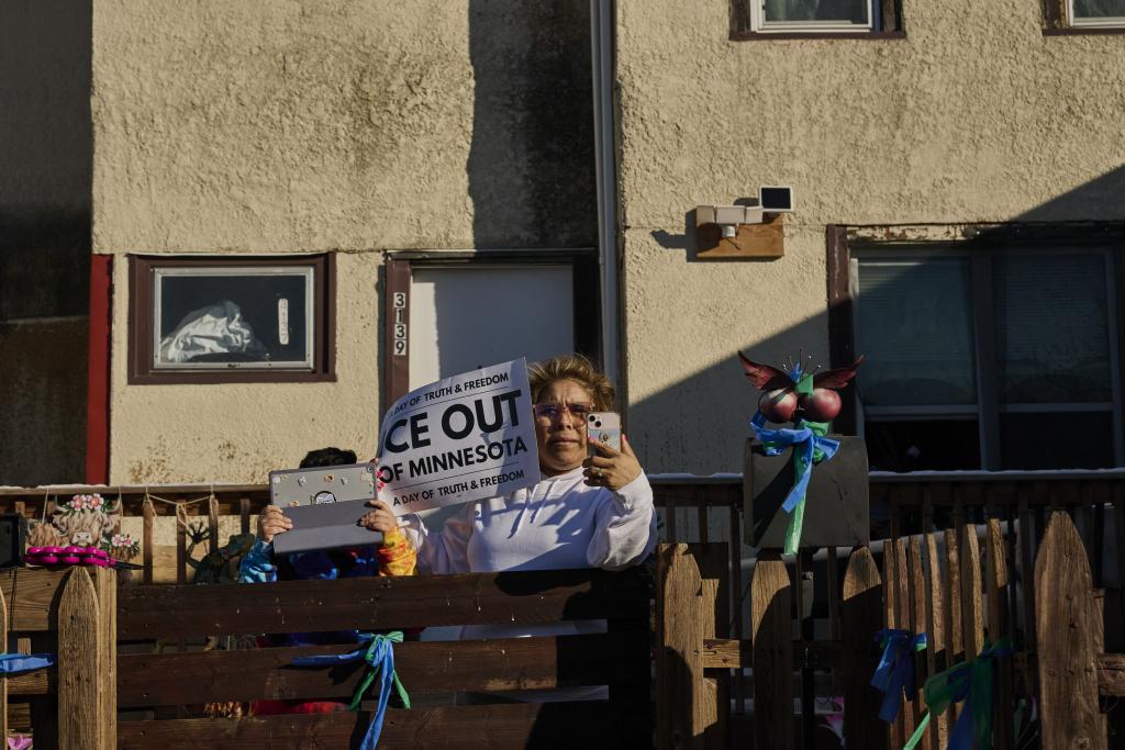  A woman and child record during a protest in Minneapolis on 31 January.