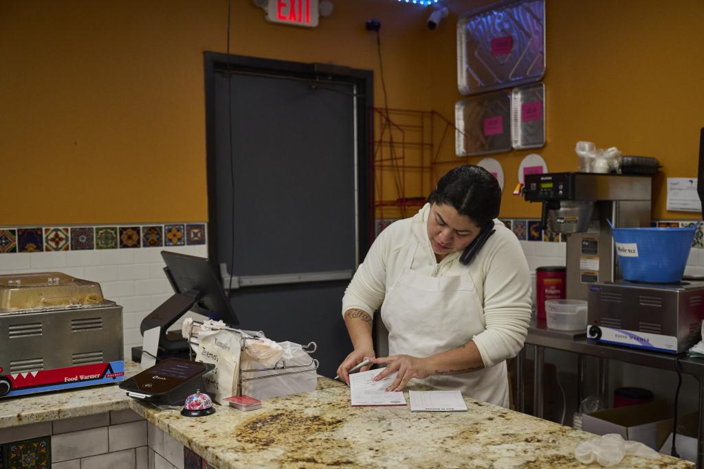 Vanessa Rubio takes phone orders at her family's bakery, Panaderia San Miguelin in Minneapolis on 6 February.