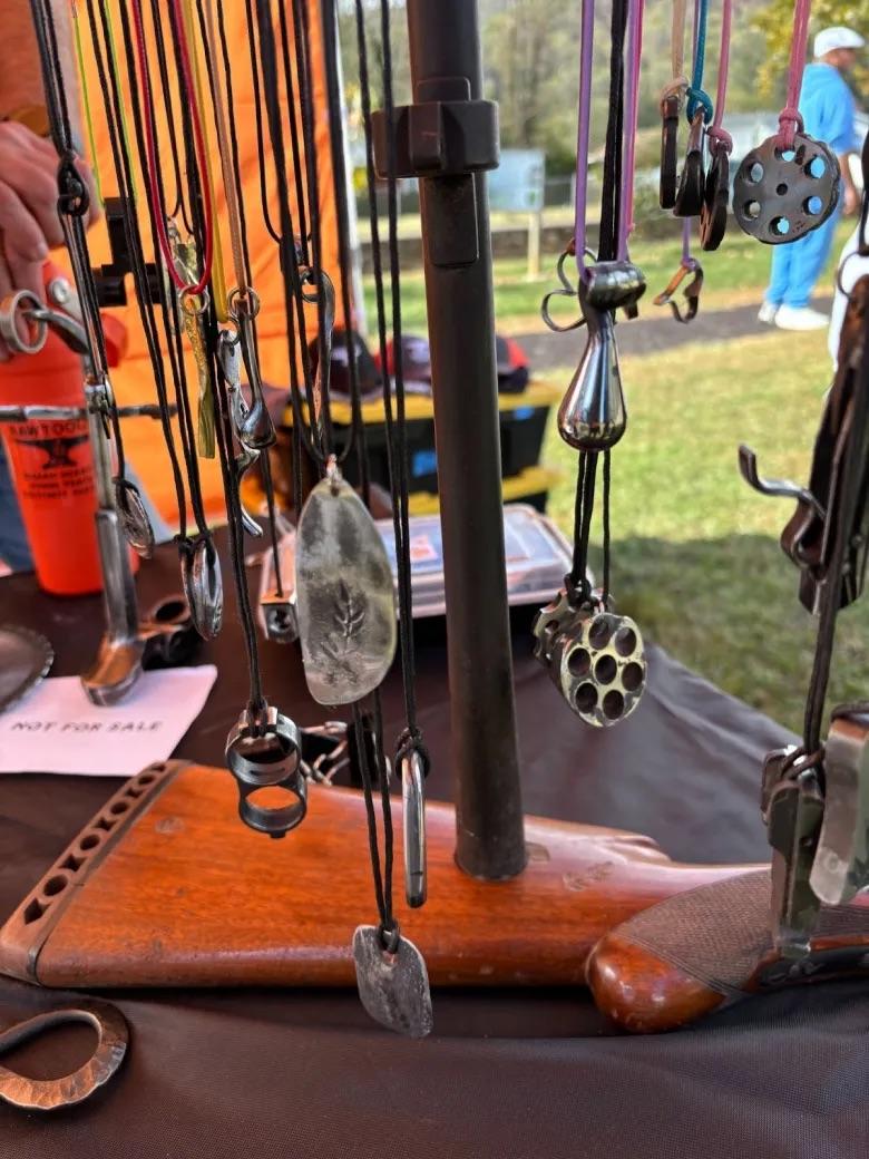 Pieces of jewelry made from parts of disabled guns, selling the jewelry and garden tools is one way RAWtools South funds their work.