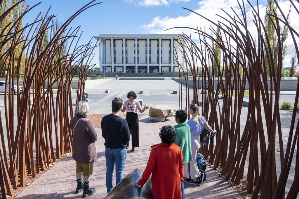 A group being guided by She Shapes History, in front of the National Library of Australia, situated in Parkes, Canberra.