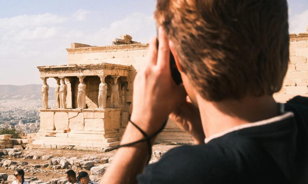 A tourist taking a photo of the Parthenon in Greece.