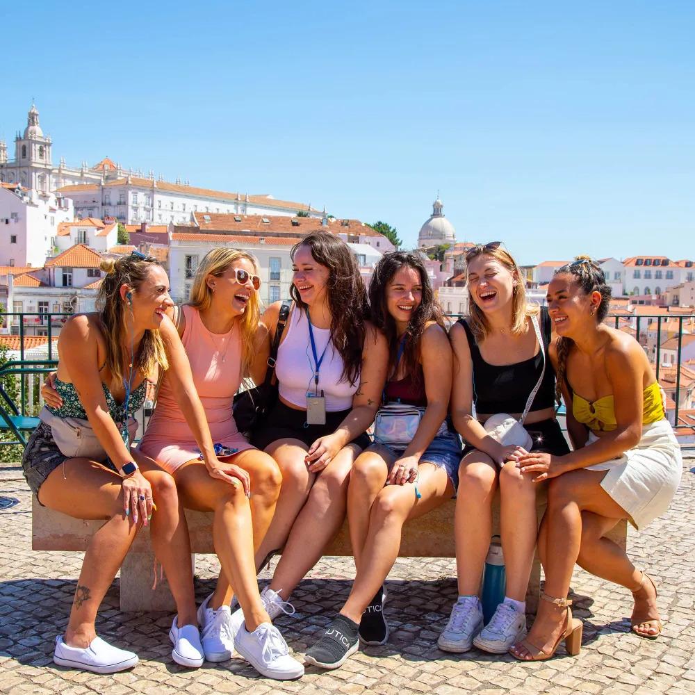 A group of friends happily enjoy their time in Portugal.
