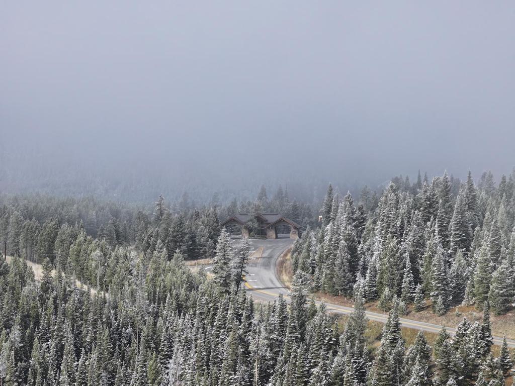 Fog descends on the entrance gate to the Yellowstone Club, a mountaintop enclave for the megarich, seen outside Big Sky, Mont.