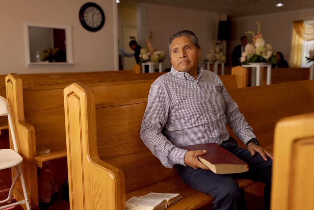 Hilario sits with his Bible after attending Sunday mass at the Spanish-language church he attends.