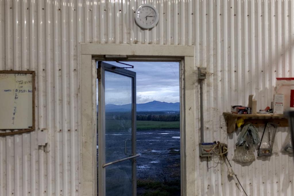 The Adirondack mountains visible through the doorway of the milk barn.