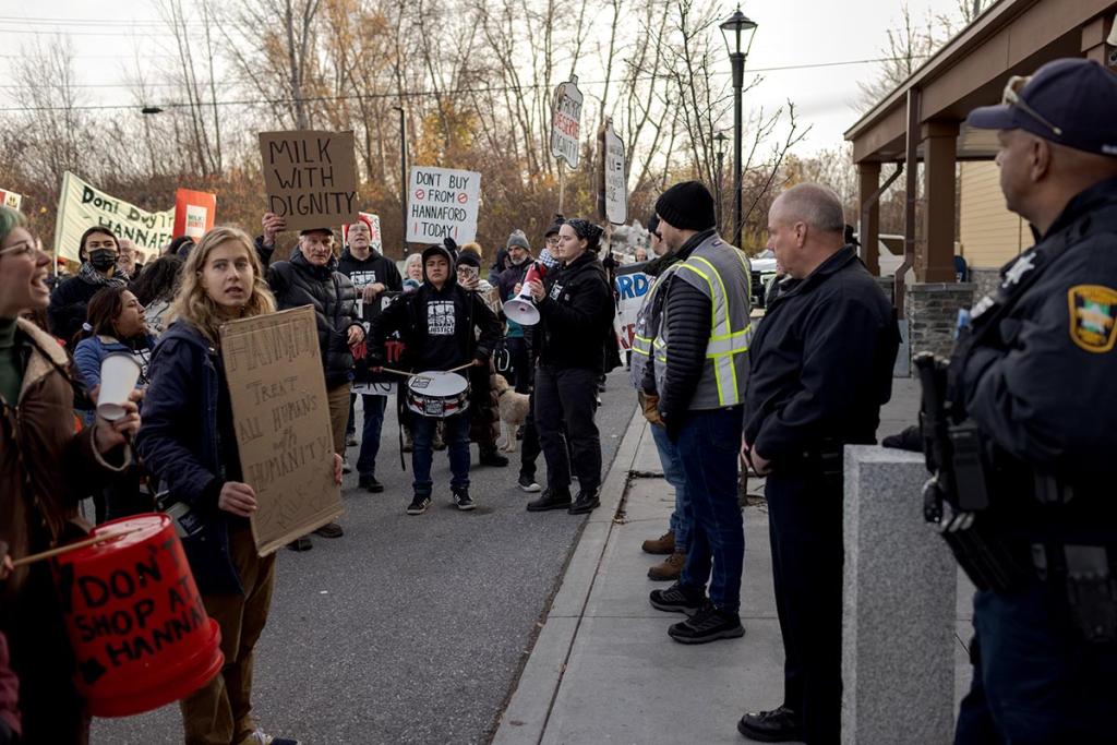Workers, community members and activists with the Migrant Justice organization protest outside a Hannaford supermarket to call on the grocery store chain to join the Milk With Dignity program in November in South Burlington, Vermont.