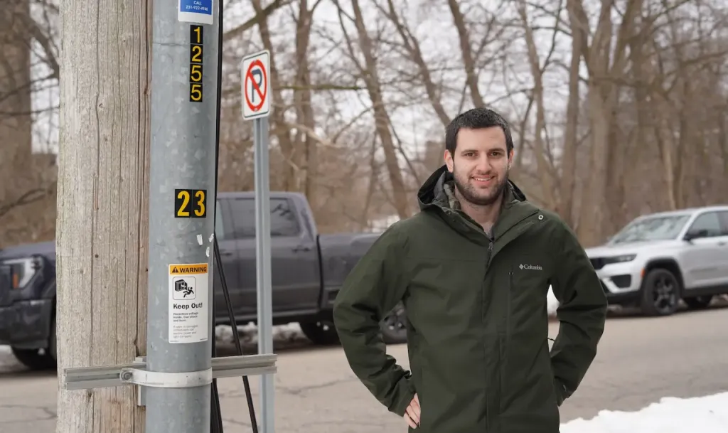 Tony Chartrand, director of electric engineering and operations for Traverse City Light & Power, stands next to a conduit containing an underground wire in Traverse City.