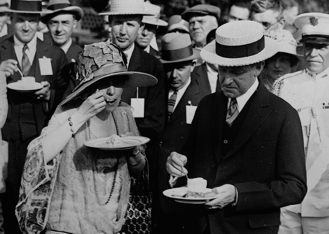 President and Mrs. Coolidge eat ice cream at a garden party for veterans at the White House.