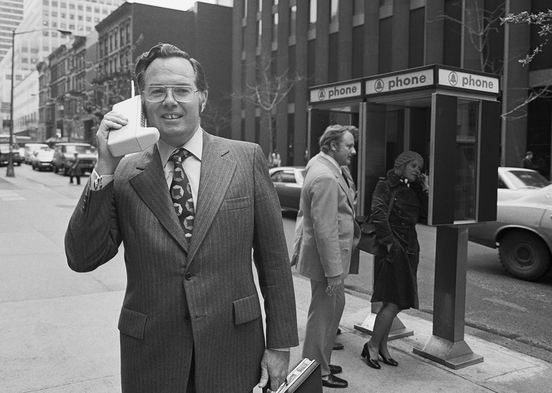 John F. Mitchell demonstrates the Motorola DynaTAC Portable Radio Telephone.
