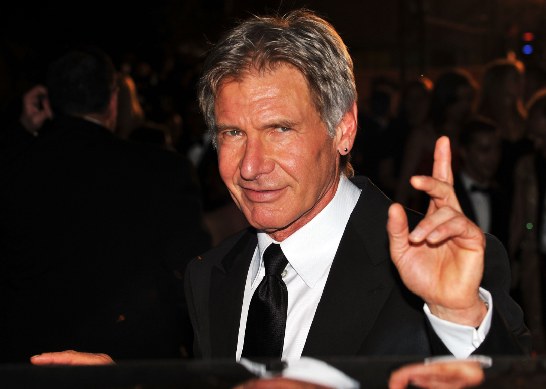 Harrison Ford smiles for a photo in Cannes