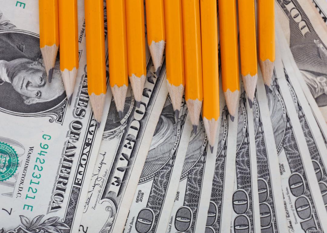 American currency and sharpened pencils.