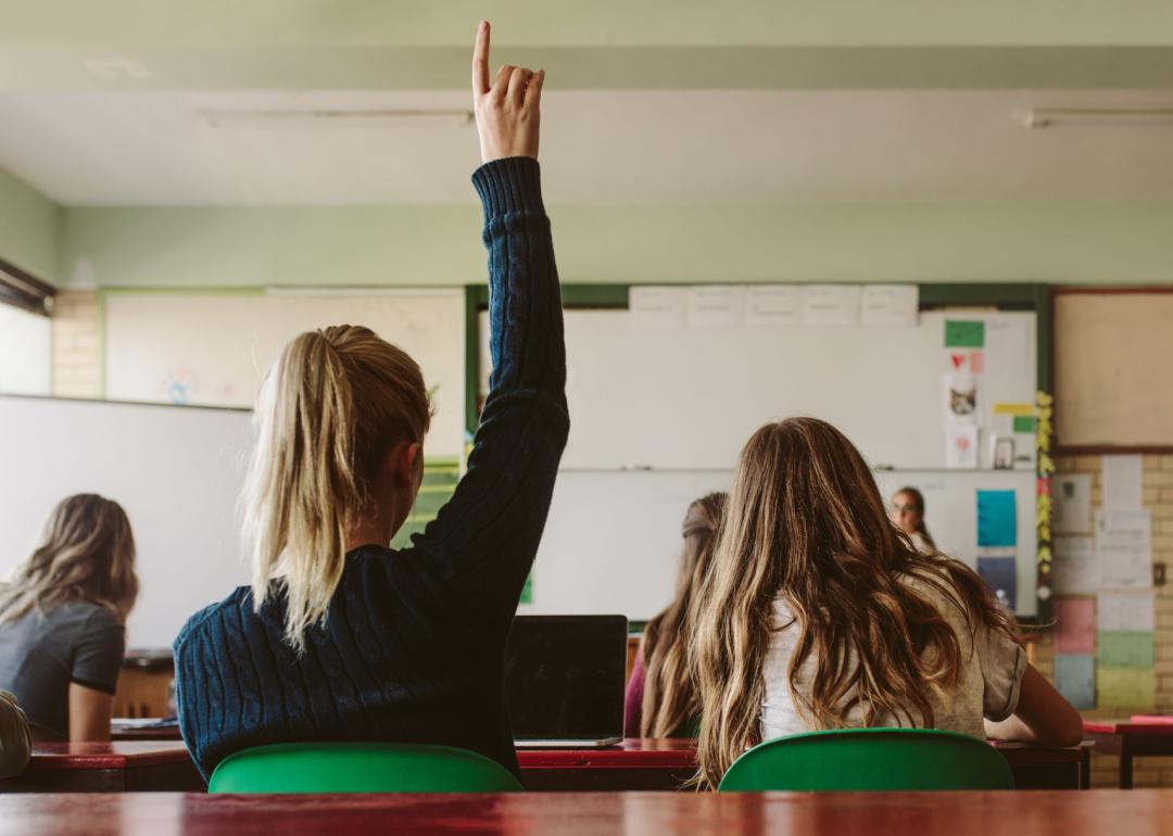 Female student raising hand in classroom