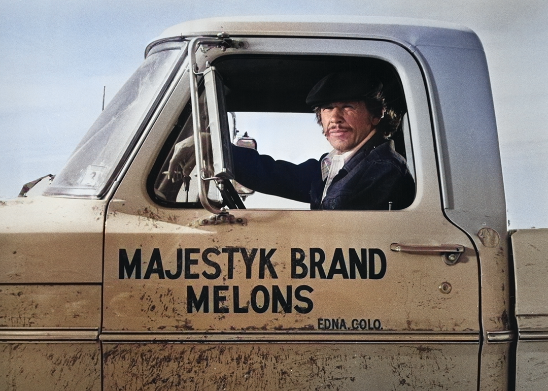 Charles Bronson sitting in the cab of a truck in ‘Mr. Majestyk’.