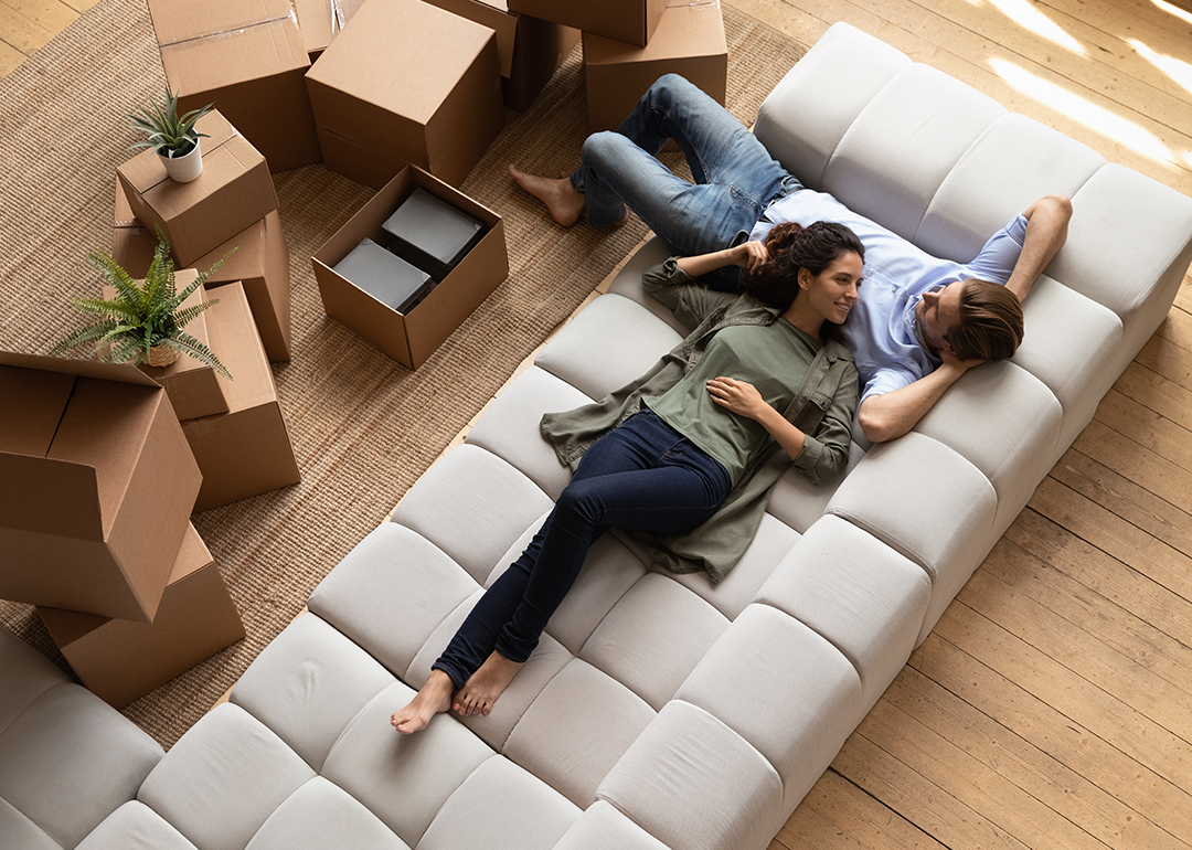 Overhead view of a couple relaxing on new sofa.