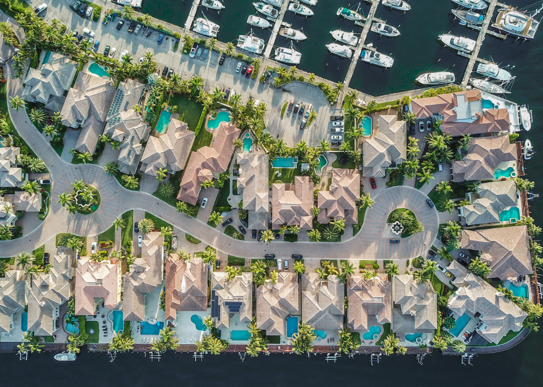 Aerial view of waterfront large single family homes with swimming pools
